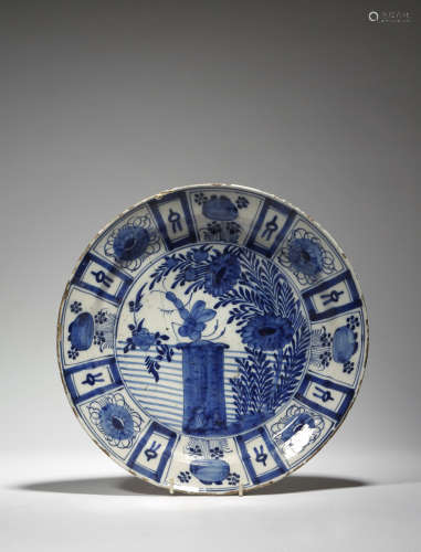 A Delft tin glazed pottery Kraak style dish, blue and white decorated with a central scene of an