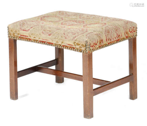 A George III mahogany stool, the stuffed-over seat with remains of original upholstery, on chamfered