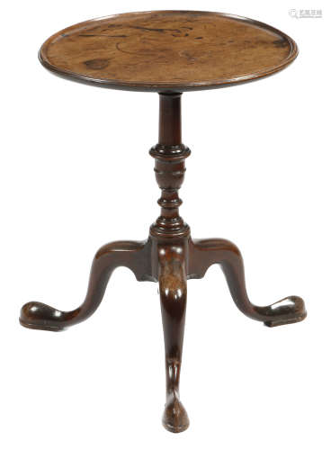 A George II mahogany tripod kettle stand, the dished fixed top on a ring turned stem, on cabriole