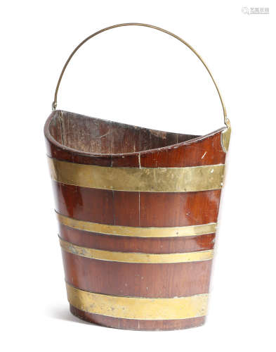 A 19th century mahogany and brass bound peat bucket, of navette shape, with a brass swing handle,