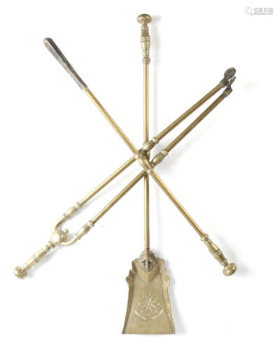 A set of three late Victorian brass fire irons, with engraved decoration, with knopped stems and
