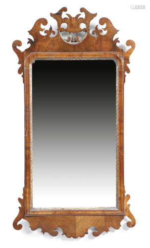 A George II walnut and parcel gilt fret-frame wall mirror, the rectangular plate with cusped top