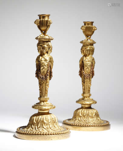 A pair of 19th century French ormolu candlesticks after a design by Jean-Demosthene Dugourc, each