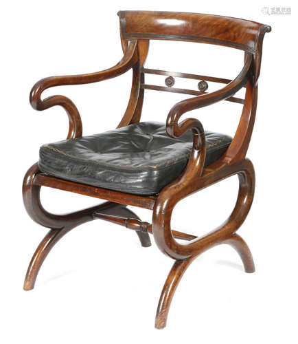 A Regency mahogany open armchair, the curved scroll reeded back above a rondel decorated