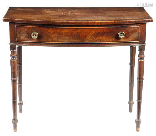 A Regency mahogany bowfront side table, the crossbanded top above a frieze drawer, on ring turned