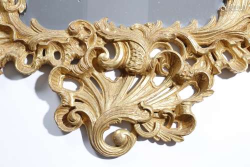 A pair of William IV carved giltwood pier mirrors in Rococo style, each with a shaped plate within a