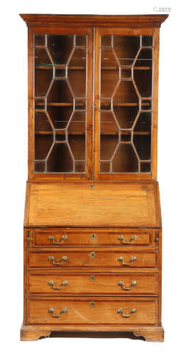 A George III walnut bureau bookcase, with a pair of astragal glazed doors enclosing three adjustable