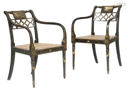 A pair of Regency ebonised and painted open armchairs, each with a tablet back, one painted with a