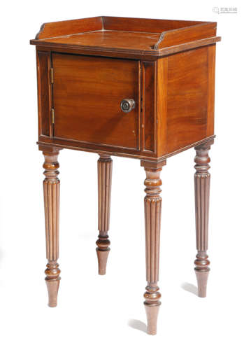 λ A George IV mahogany bedside cupboard attributed to Gillows, with a reeded three quarter gallery