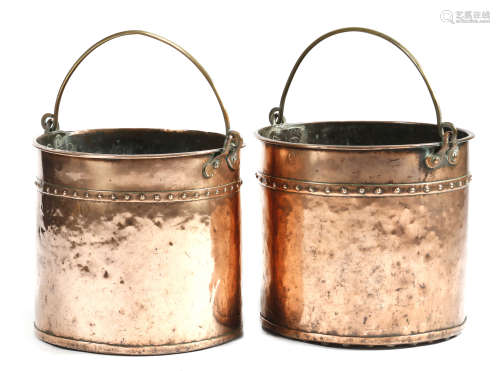 A matched pair of 19th century copper logbins, each with a brass swing handle and a riveted body,