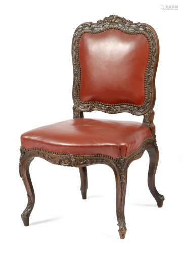 A Louis XV period walnut side chair, with a later leather padded back and seat, the frame finely