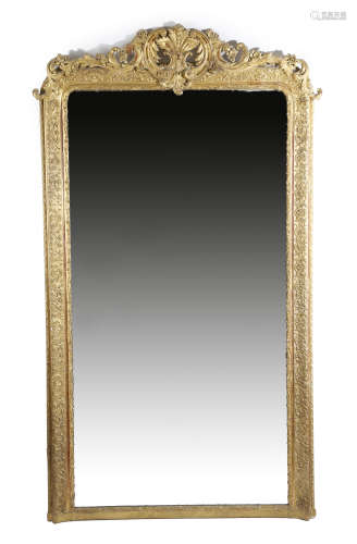 A French giltwood and composition pier mirror in Louis XV style, the arched plate within a leaf
