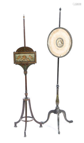 Two late George III painted pole firescreens, each with an adjustable panel, one painted with winged