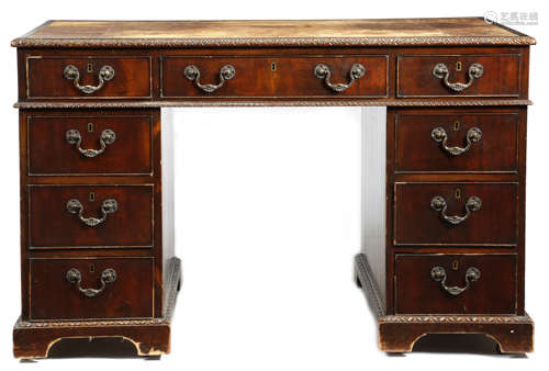 A mahogany twin pedestal desk in Chippendale style by Spillman, the top inset with a tooled