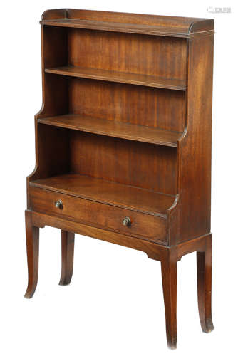 A mahogany waterfall open bookcase in Regency style, with reeded mouldings, the base with a