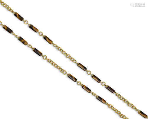 A tiger's eye long guard chain by Tiffany & Co, the circular gold links divided by tiger's eye