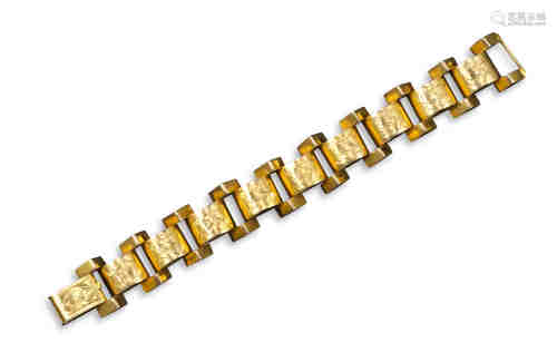 A tank track gold bracelet, set with chevron and semi-spherical links engraved with foliate