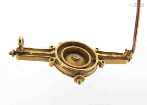 A late 19th century Etruscan revival gold brooch, set with a ram's head within gold wirework and