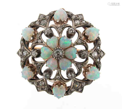 An Edwardian opal and diamond circular brooch pendant, centred with a circular-cut diamond within