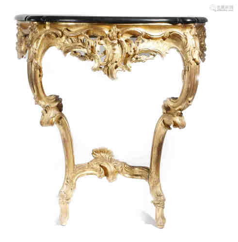 A Louis XV giltwood console table, the later black marble top with a serpentine edge, the foliate