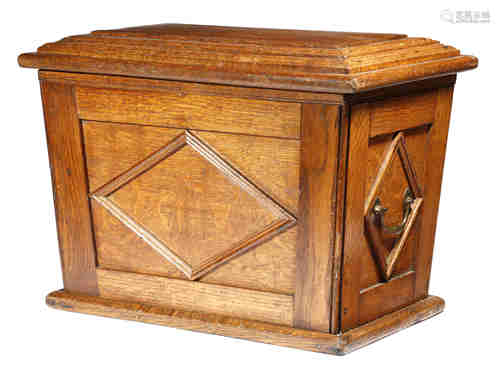 A William IV oak trunk or box, of sarcophagus shape, the stepped hinged lid revealing a vacant