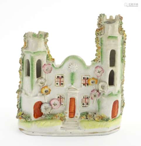 A Staffordshire pottery pastille burner in the form of a castle with floral decoration. Approx.