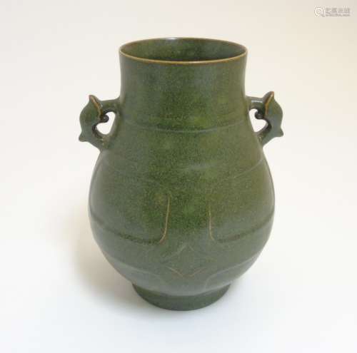 A Chinese tea dust glazed Hu vase, having handles in the form of the tianlu animal,