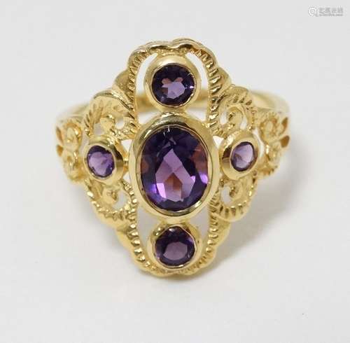 A silver gilt dress ring set with amethysts.