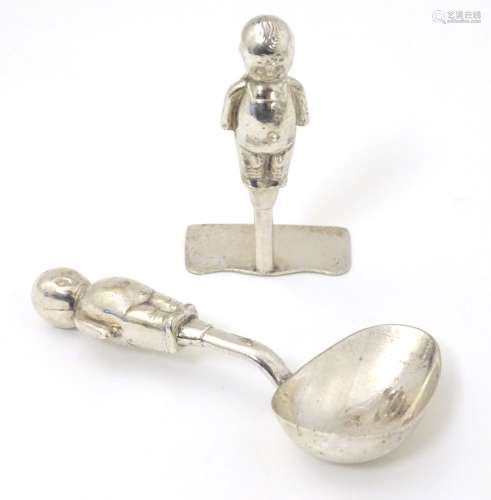 A silver plate Christening set comprising spoon and pusher with handles formed as stylised Kewpie