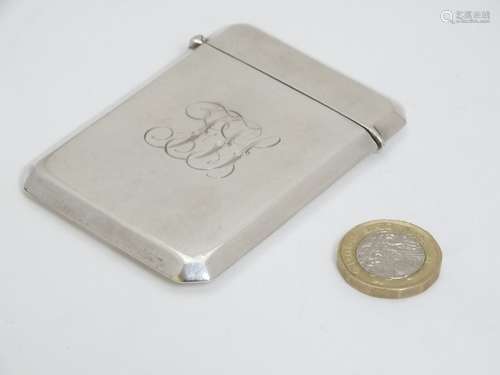 A silver visiting card case with hinged lid and canted corners.