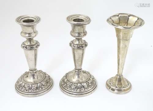 A pair of silver candlesticks hallmarked Birmingham 1911 maker John Thompson & Sons.