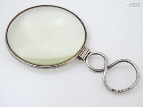 A magnifying glass with silver handle hallmarked London 1848 maker JWH.