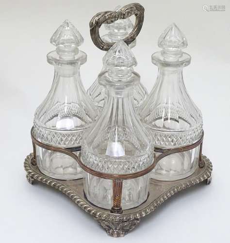 A 4- bottle Sheffield plate stand with 4 cut glass small decanters.