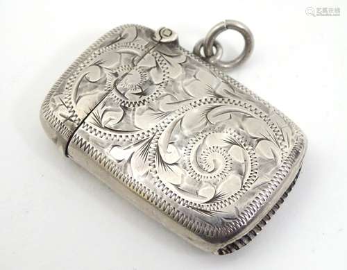 An early 20thC silver vesta case with engraved acanthus scroll decoration.