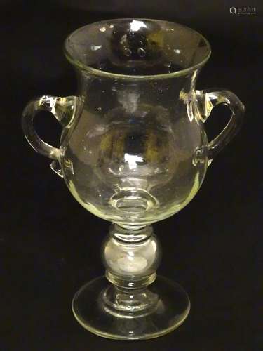 George V pedestal glass 2 handled Goblet with air knop stem having a George V Coin within,