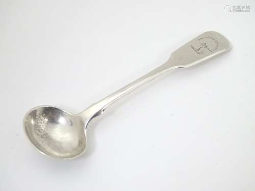 A Victorian silver fiddle pattern salt spoon with engraved armorial and motto to handle ,