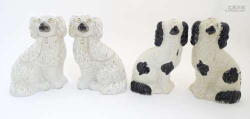 Two pairs of Staffordshire Victorian seated spaniels.