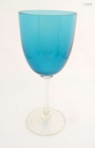 An oversized wine glass with a turquoise bowl, 13