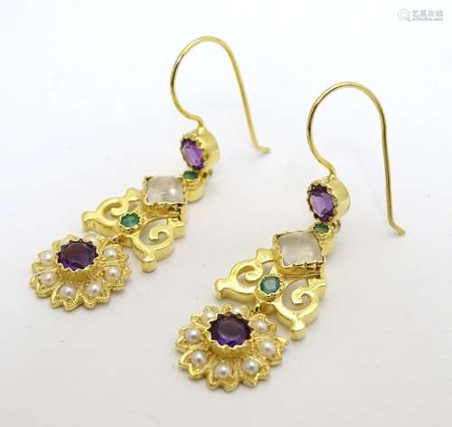 A pair of silver gilt drop earrings set with pearls, moonstone, amethysts and peridot stones.