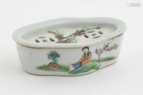 A Chinese lozenge lidded dish hand painted with 4 character markings and a figure in a landscape to