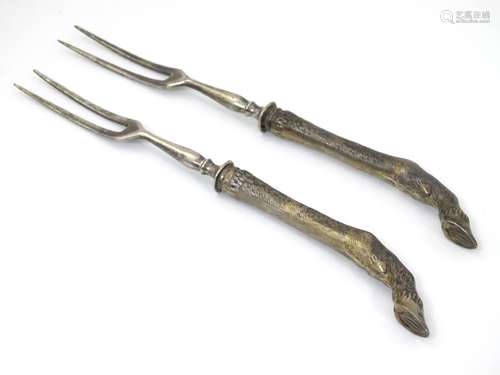 A pair of Late 19thC / early 20thC two tine forks having handles formed as animal legs with cloven