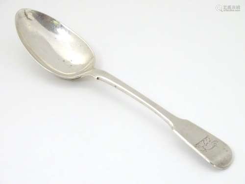 A silver fiddle pattern dessert spoon having engraved wild boar armorial to handle.