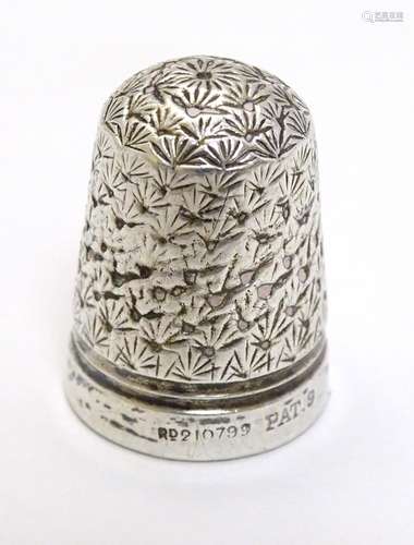 A white metal thimble with reg des. no for c.