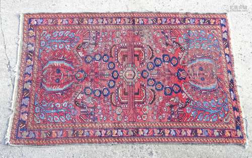 Rug / carpet : a Persian hand made a wine red ground rug with three distinct borders , having blue ,