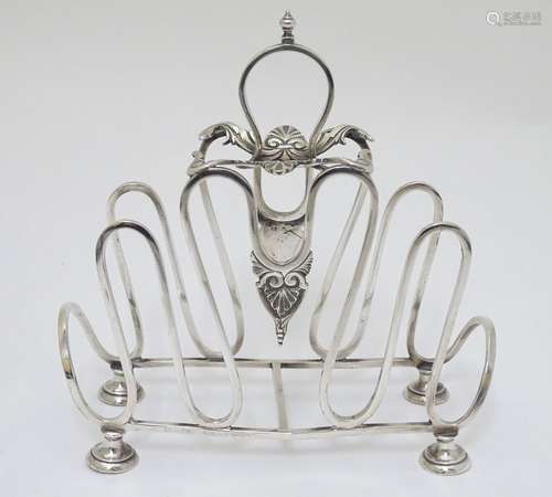 A silver plate toast / letter rack with scroll and shell decoration 7