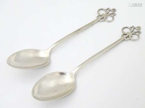 A pair of silver teaspoons with openwork decoration to handles.