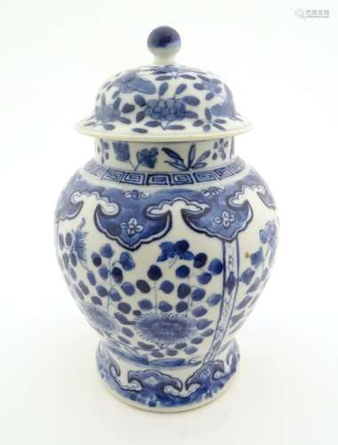 A Chinese blue and white ginger jar with panelled floral and butterfly decoration,