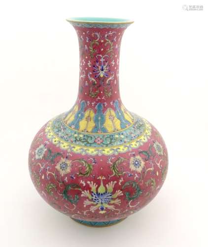 A Chinese famille rose baluster vase decorated with flowers and foliage,