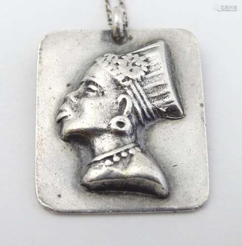 A silver pendant with image of South African female head.