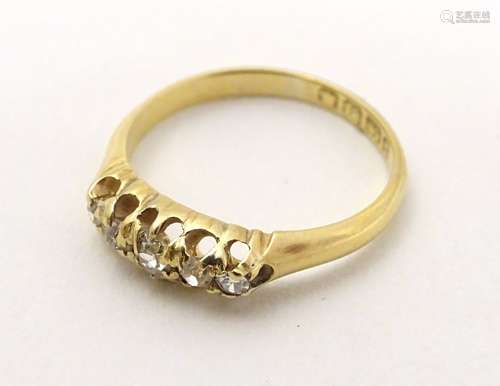 A Victorian 18ct gold ring set with 5 graduated diamonds.